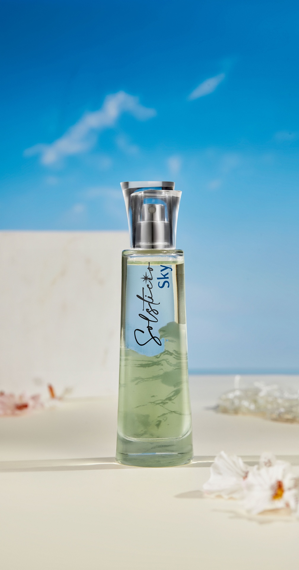 Solstice Sky fragrance bottle with blue sky and hibiscus
