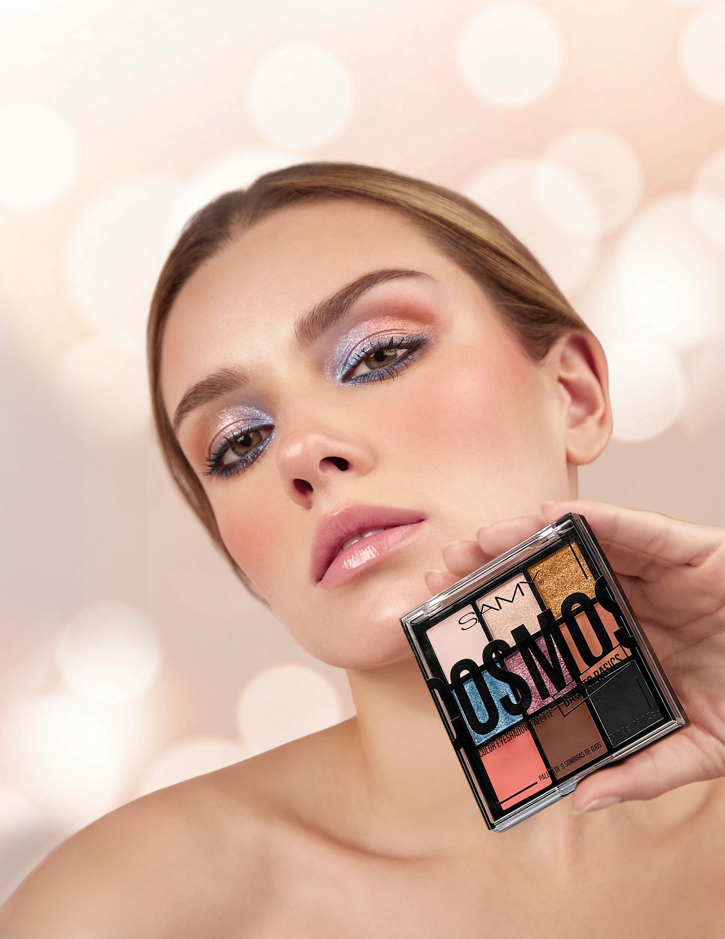 Beauty portrait holding Cosmos eyeshadow palette with bokeh