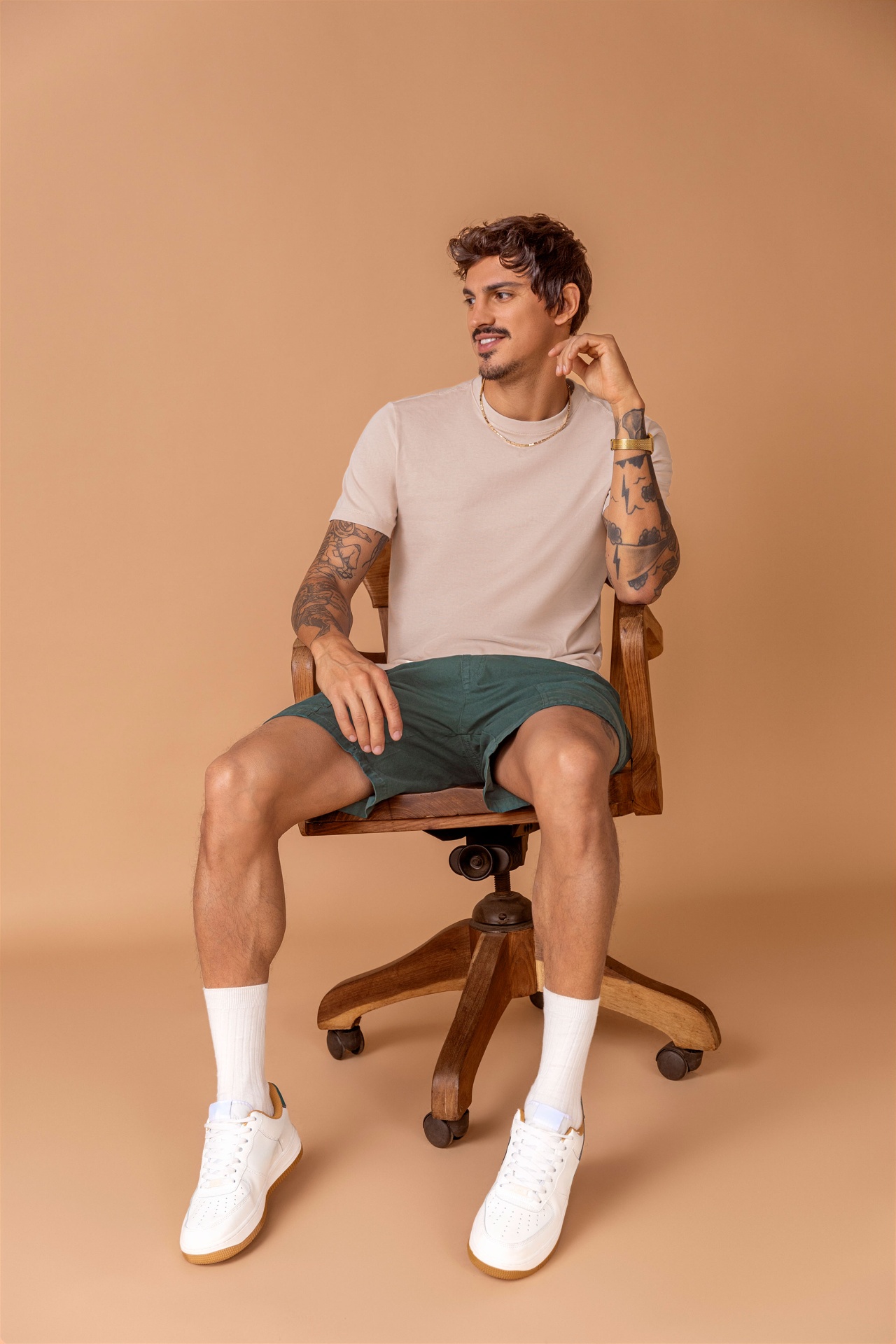 Menswear studio portrait on vintage wooden chair