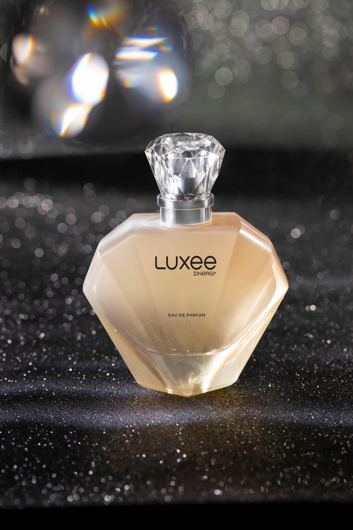 Luxee Zinergy diamond-cut fragrance bottle with bokeh