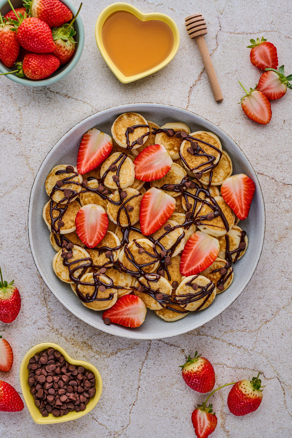 Overhead mini pancakes with strawberries and chocolate