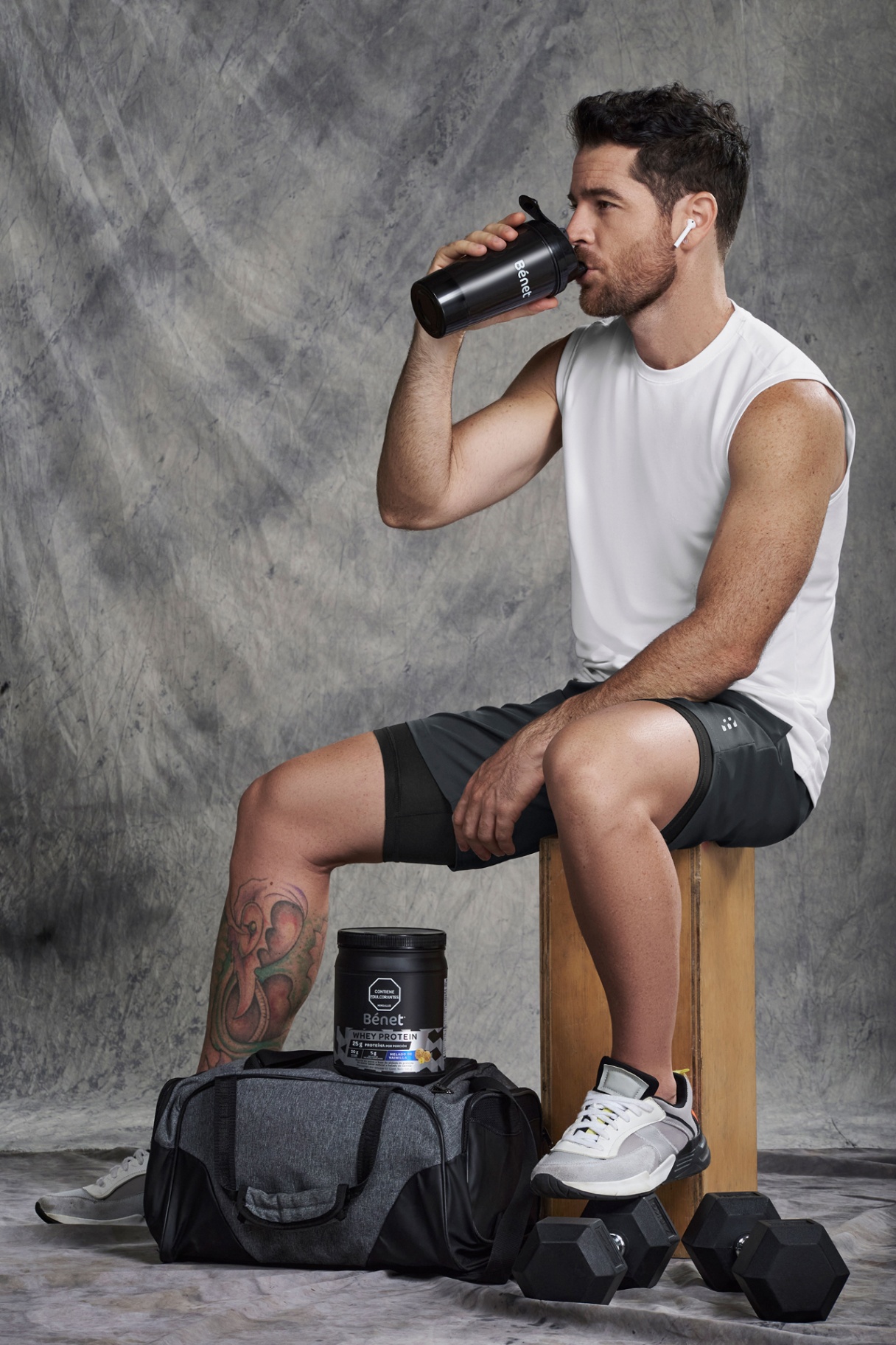Man drinking Bénet Whey Protein shake in studio