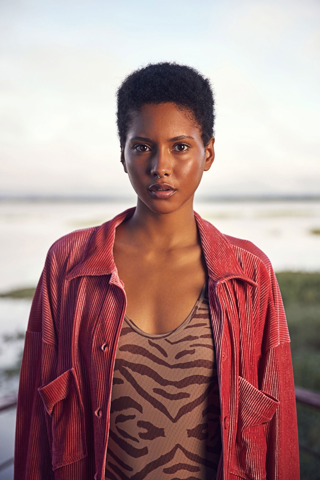 Editorial portrait with coral corduroy jacket