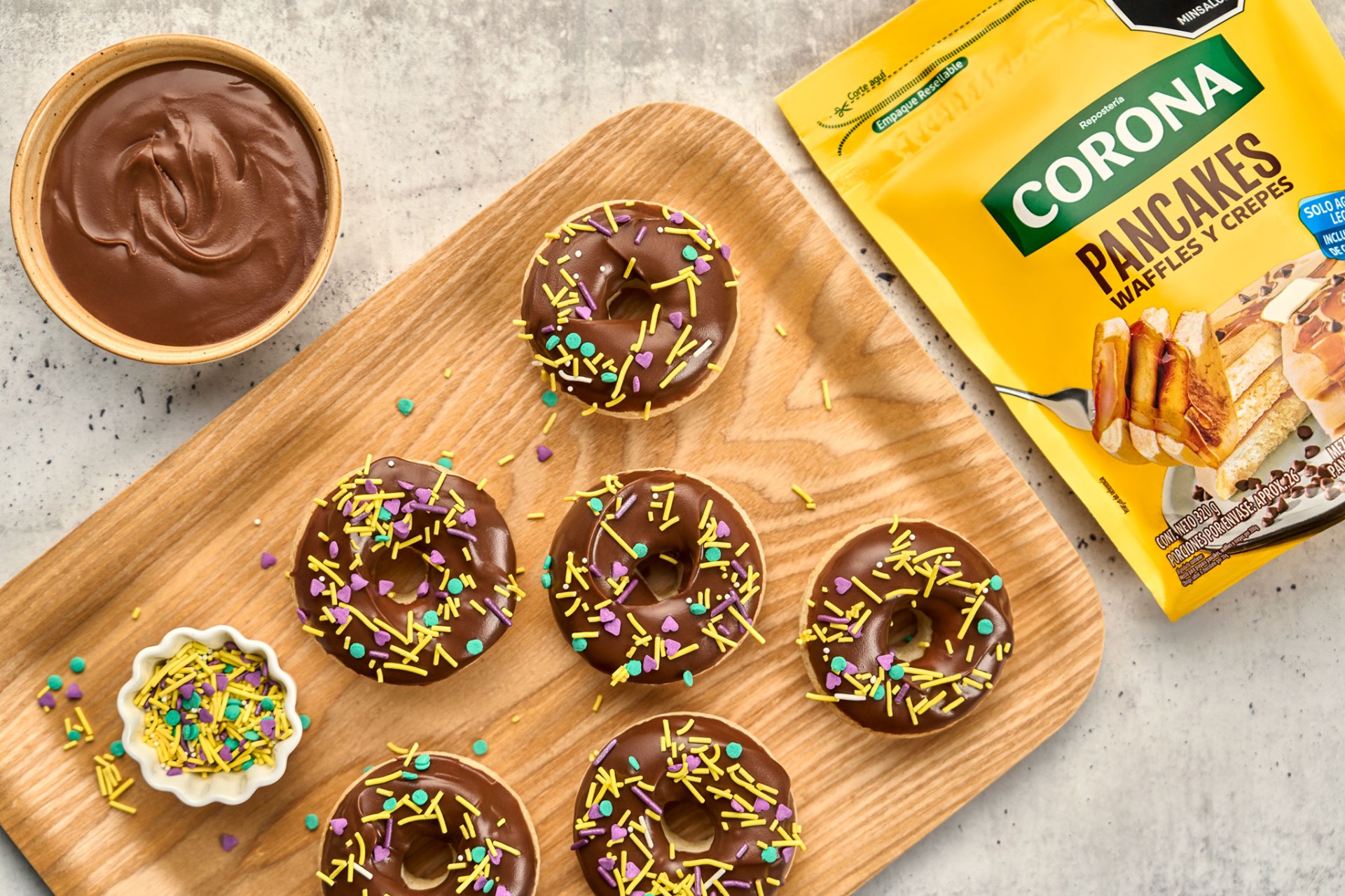 Overhead chocolate donuts with sprinkles and Corona pancake mix